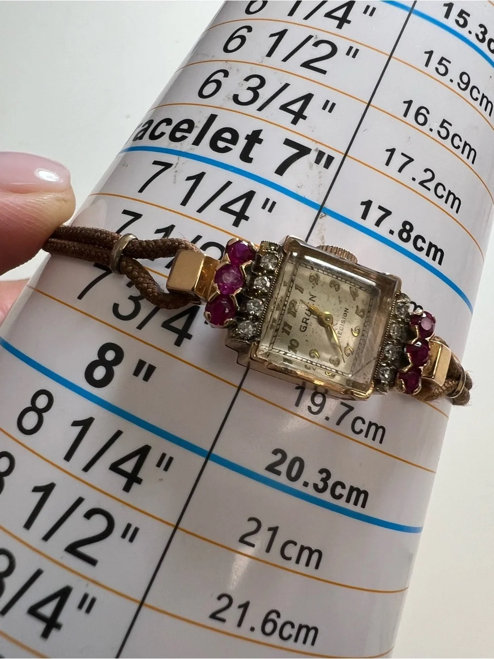 Gruen Precision wristwatch crafted in 14k rose gold with rubies and diamonds